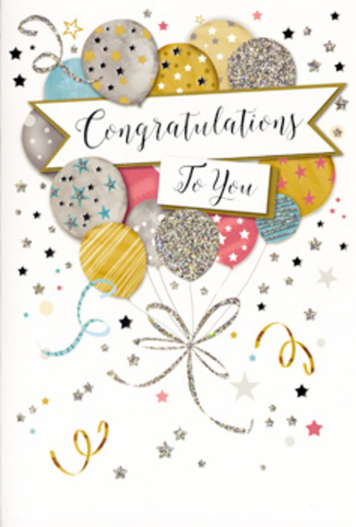 The photograph showcases a single congratulations card standing upright on a simple surface, its artwork turning the front into a stylish celebration in miniature, much like a thoughtfully curated display in Florist Beckton's window. In the centre, a bouquet of illustrated balloons floats upward, their rounded shapes gently overlapping and creating a sense of depth, as if they are slowly drifting above the rooftops around Beckton Triangle. The balloons are painted in soft metallic hues-warm gold, cool silver, champagne, blush pink, powder blue, and quiet grey-that together create an elegant, uplifting palette. Each balloon features a unique decorative detail: some are ringed with sparkling glitter stripes, others are scattered with tiny starbursts, and a few are dusted with fine, shimmering dots that catch the eye much like sunlight glancing off the water near Gallions Reach. From the base of the balloons, narrow ribbons in metallic gold and silver trail downward in sinuous curls, weaving over one another until they gather into a single, neat knot that acts as a visual anchor. Across the midsection of the card, a softly curved banner ribbon stretches from side to side, bearing the message Congratulations To You in flowing, ornate calligraphy that feels both personal and quietly grand, suitable for honouring exam successes, work milestones, or special achievements within the Beckton community. Surrounding the central motif, a pale, uncluttered background is sprinkled with tiny metallic stars, delicate confetti dots, and subtle swirling accents, suggesting the gentle motion of a celebration just beginning. The design looks as though parts of it are lightly textured, with raised glitter and glossy ink that would feel pleasing beneath your fingertips. The overall impression is one of polished joy and heartfelt pride, a card that seems made to accompany flowers delivered across Beckton for those luminous, once-in-a-while moments.
