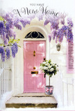 This doorway scene from Beckton feels like a gentle pause between unpacked boxes and the first cup of tea in a new home. At its centre is a beautifully painted pink door, its pastel tone calm and understated, framed by whitewashed walls that reflect the soft light of an overcast but bright East London day. To one side, a pale shutter echoes the same blush shade, giving the façade a cohesive, well-loved look reminiscent of the tidy houses around Beckton Park. Above the entrance, wisteria cascades in flowing curtains of lavender and lilac, the clusters of blossoms tumbling downward in graceful arcs that soften the architecture with natural charm. You can almost imagine the light rustle of the vines and the subtle, sweet scent of the flowers drifting across the step. Positioned at the base of the door, a grey metal bucket has been filled to overflowing with creamy white and ivory roses. Each rose appears carefully placed, with petals that look soft enough to touch, some blooms full and open, others cupped more tightly as if just beginning to unfurl. Between them, fresh green foliage provides contrast, making the whites seem even more luminous. A satin ribbon in matching pink wraps around the bucket, tied into a simple, elegant bow that rests against the stone, its trailing ends mirroring the hanging wisteria above. The whole composition is bathed in gentle light, creating a peaceful, optimistic atmosphere. It suggests a moment of quiet pride and contentment, the kind of floral welcome a resident of Beckton might choose to mark the start of a new chapter, offering beauty, comfort, and a sense that this place is truly becoming home.